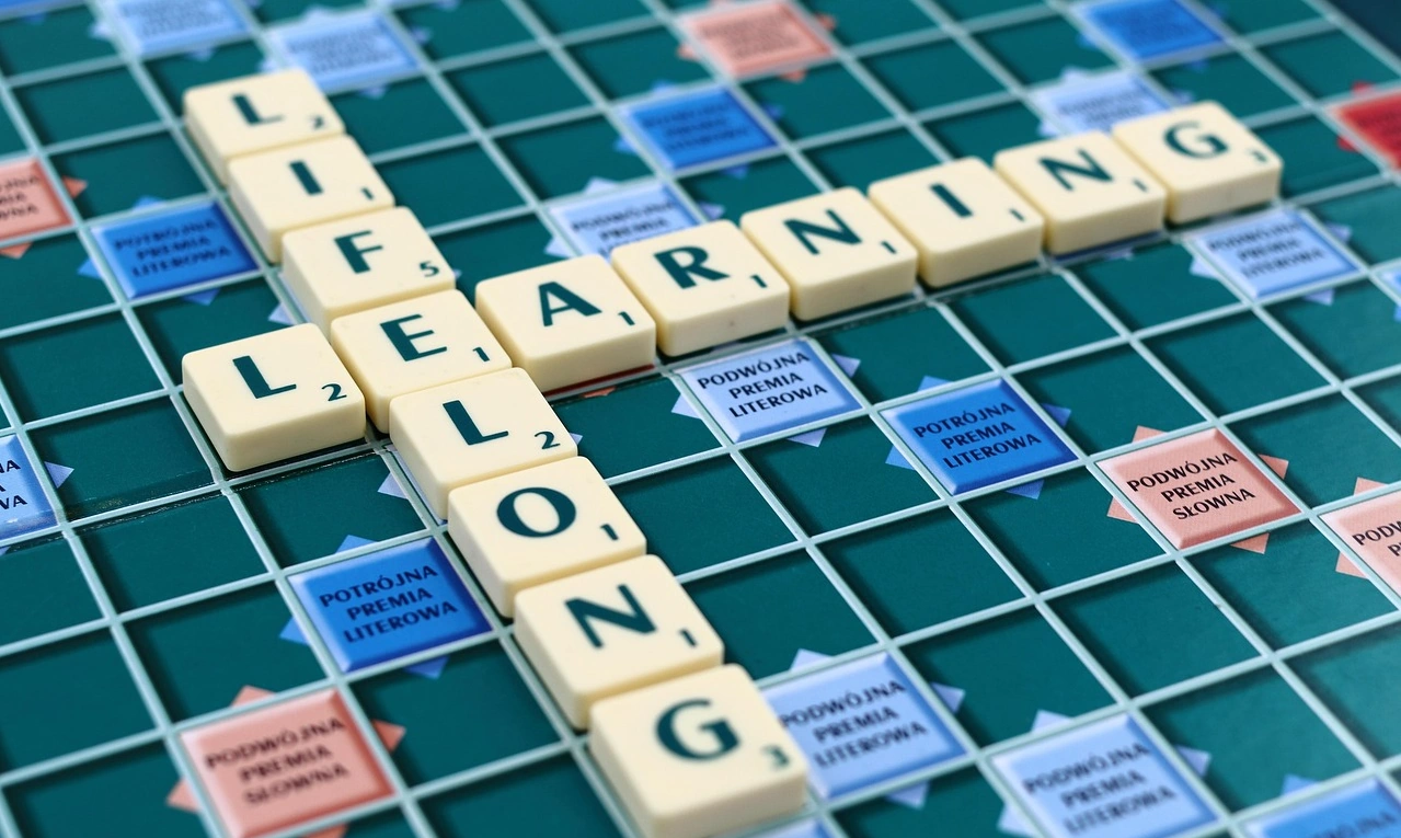 pieces on a board spelling lifelong learning