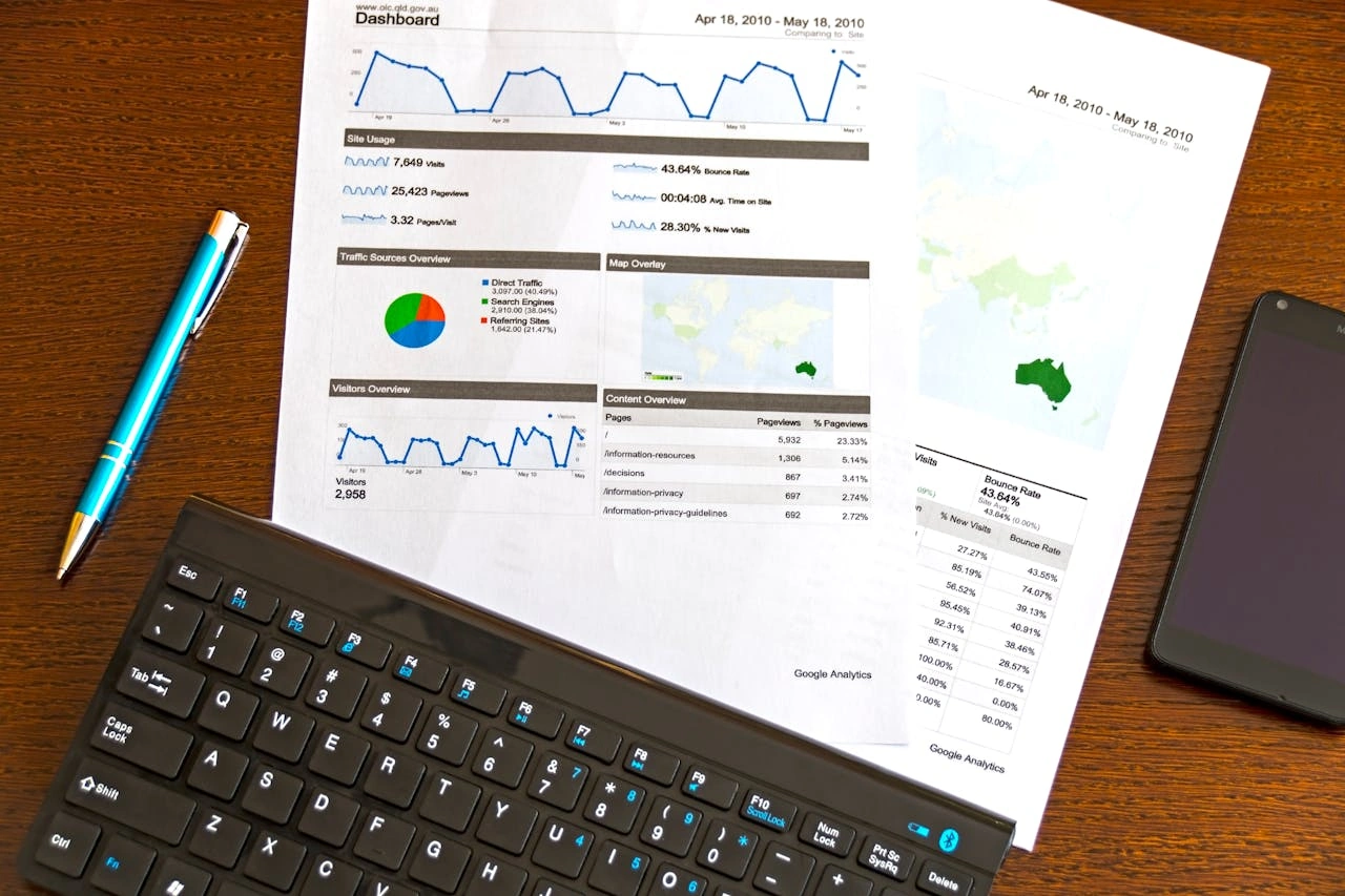 charts and graphs showing analytics and a black keyboard on a table