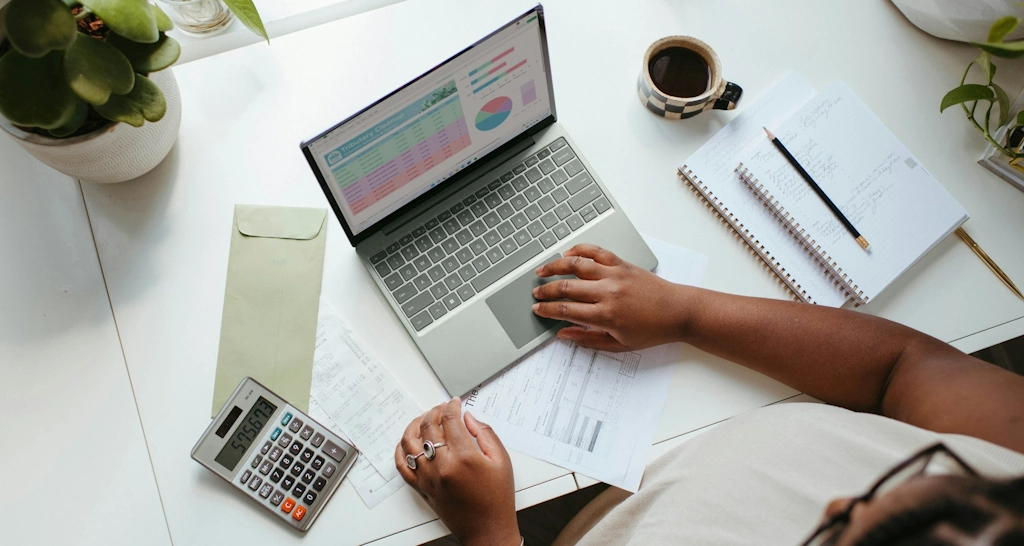 a person sitting at a table with a laptop
